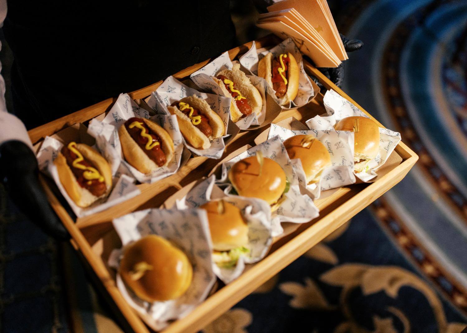 Gourmet catering options including mini hotdogs and burgers at Arts District Mansion